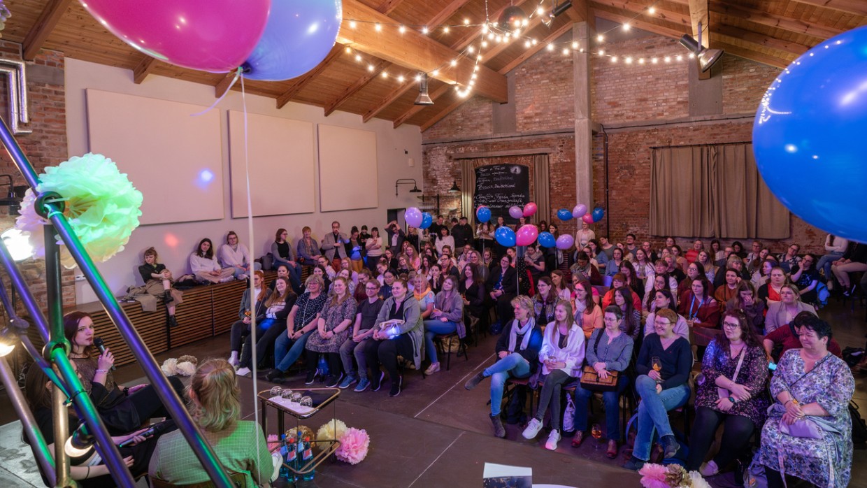 Leipzig liest Event mit Bühnentalk vor vollbesetztem Publikum in einem großen, mit Luftballons und Lichterketten geschmückten Raum während der Leipziger Buchmesse 2024 Leipzig liest Event mit Bühnentalk vor vollbesetztem Publikum in einem großen, mit Luftballons und Lichterketten geschmückten Raum während der Leipziger Buchmesse 2024